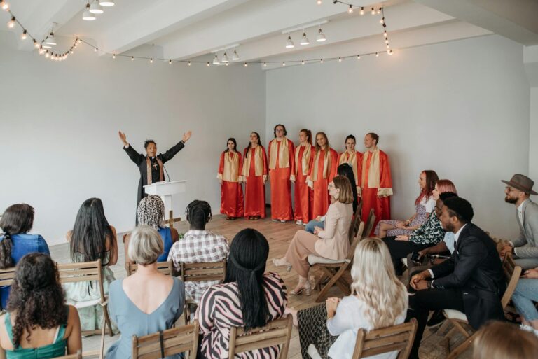 A vibrant choir performing for a congregation led by a female pastor in a church hall.